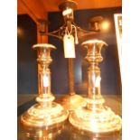 A pair of silver-plated candlesticks and a rustic wrought iron candelabra
