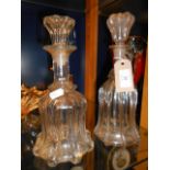 A pair of fluted glass decanters of waisted form