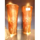 A pair of Art Nouveau hand beaten copper trumpet vases with stylised embossed iris flowers,