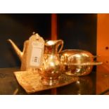 A silver-plated muffin dish, tea pot,