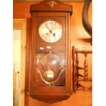 A 1930's oak cased 'Haller' wall clock with silvered dial and Arabic numerals
