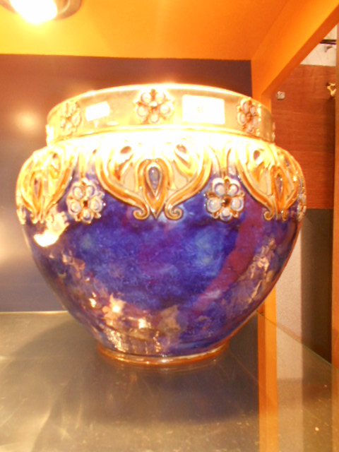 A large Royal Doulton Art Nouveau blue ground jardiniere decorated with tulips and flowers