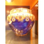 A large Royal Doulton Art Nouveau blue ground jardiniere decorated with tulips and flowers