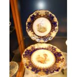 A pair of 1830 Spode cobalt blue and gilt bordered plates with pictorial landscape panels