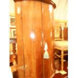 A Georgian mahogany bow-fronted corner cabinet,