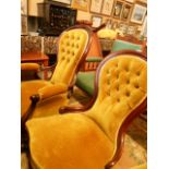 A pair of Victorian rosewood framed his and her salon chairs, each with spoon shaped button back,