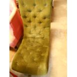 A late Victorian green upholstered button back sleigh shaped nursing chair raised on turned