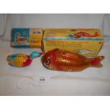 An original Chinese tin plate whale eating fish boxed and a tin plate clock work swimming plate
