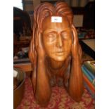 A carved wooden female bust