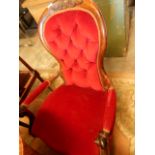 A Victorian mahogany framed spoon back floral carved armchair in red upholstery (A/F)
