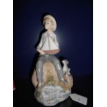 A Lladro figurine of a 'Boy with Pond Yacht and Puppy'