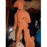 A terracotta figure of a woodsman inscribed 'Retour du Bois' and signed to base