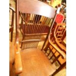 An early 20th C oak farmhouse elbow chair,