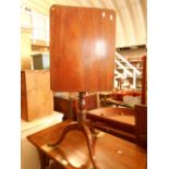A Victorian mahogany tilt-top side table the rectangular top with canted corners raised on a turned