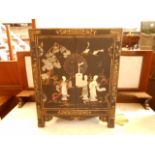 A mid-20th C Japanese black lacquered table cabinet decorated in relief with soap stone geisha