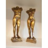 A pair of bronze classical nude male and female sculptures on pedestal bases