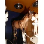 A Beswick model of a chestnut brown horse with tail attached to left hind leg  In