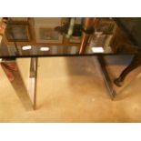 A 1970's - 80's square smoked glass topped occasional table on chrome supports