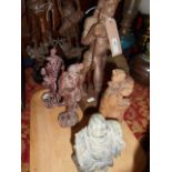 Three Oriental carved wooden figures,