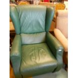 A green leather reclining wing back chair