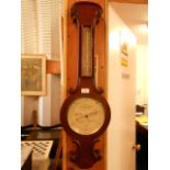 An early 20th C walnut cased banjo barometer with thermometer above inscribed J.B.