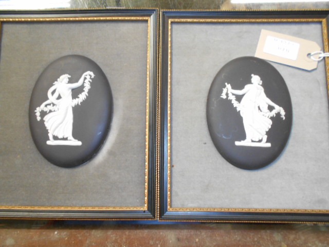 A pair of Wedgwood black Jasperware oval plaque depicting classical females housed in velvet