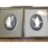 A pair of Wedgwood black Jasperware oval plaque depicting classical females housed in velvet
