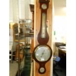 A Victorian walnut ebony strung barometer and thermometer the silvered dial inscribed R Banks & Son