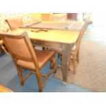 A Victorian oak wind-out dining table with extra leaf raised on square tapering supports
