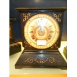 A 19th C Ansonia clock company slate mantle clock with brass dial and Roman numerals and flanked by