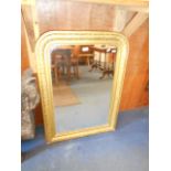 A late 19th C gilt gesso wall mirror with floral frame