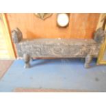 An African carved wooden window seat with animal features and storage chest