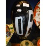 A black and white cased glass vase of oval form,