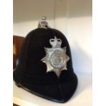 A vintage Humberside Police helmet of six panel design with chrome badge and ball finial,