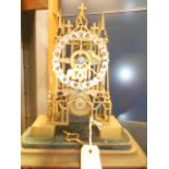 A 19th C brass skeleton clock of Gothic design with fusee movement and silvered chapter ring,