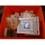 A box of wooden and rubber craft stamps to include flowers, buildings,