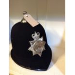 A vintage six panel design Humberside police helmet with chrome badge and ball finial,