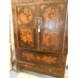 A large early 20th C Japanese black lacquered cabinet decorated with figural panels, dragons,