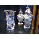 A Dutch Delft garniture set having blue glazed cartouche's with portrait panels and lion finials