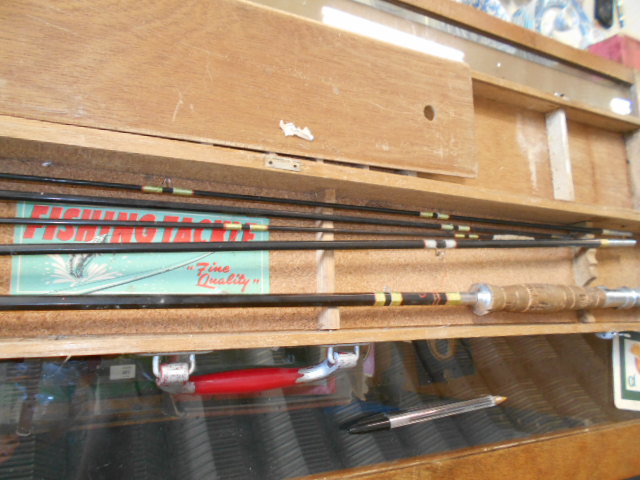 A mid-20th C cane fly fishing rod with changeable tips housed in a wooden case