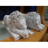 A pair of high quality crushed marble recumbent lions with medallions inset to base