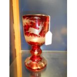 A 19th C Bohemian ruby glass goblet wheel engraved with deer in amongst trees,