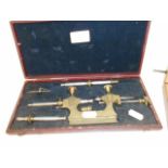 A late 19th C early 20th C cased French brass and steel precision lathe