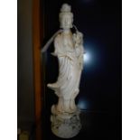 A blanc de chine porcelain figure or an Oriental female raised on a floral encrusted base