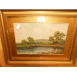 An early 20thC oil on board landscape depicting a river with trees and hills beyond the far bank,