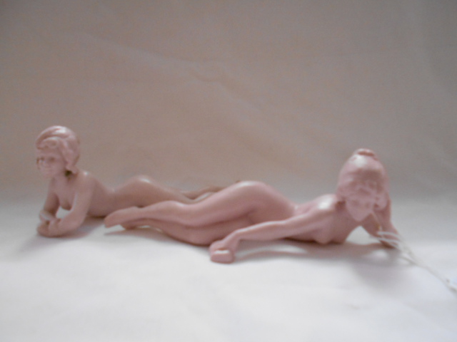 A pair of bisque Continental slumbering naked female figurines