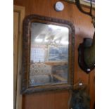 A Victorian walnut mirror carved with poppies and leaves