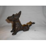 A cast metal smokers companion in the form of a Scottie dog
