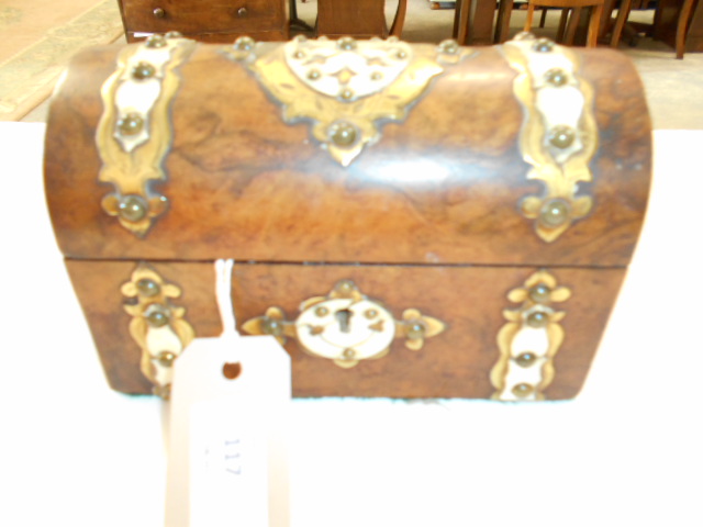 A burr walnut domed top casket with ornate brass and Ivorine escutcheons,