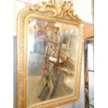 A 19th C gilt gesso floral decorated wall mirror surmounted with scrolling swags